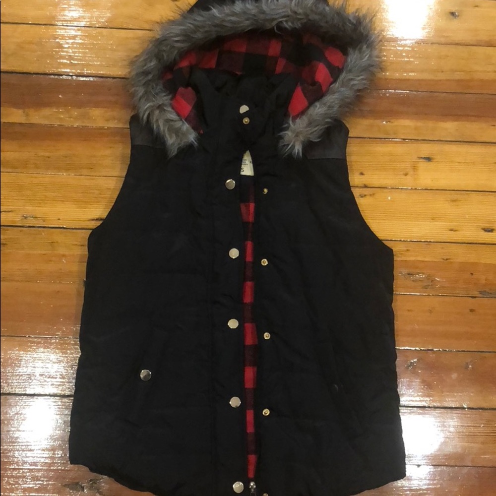 Black vest with leather trim on back